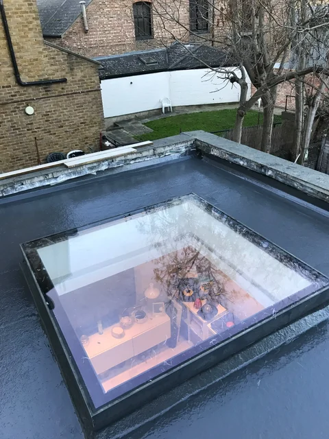 Flat roof with a rectangular rooflight viewed from above.